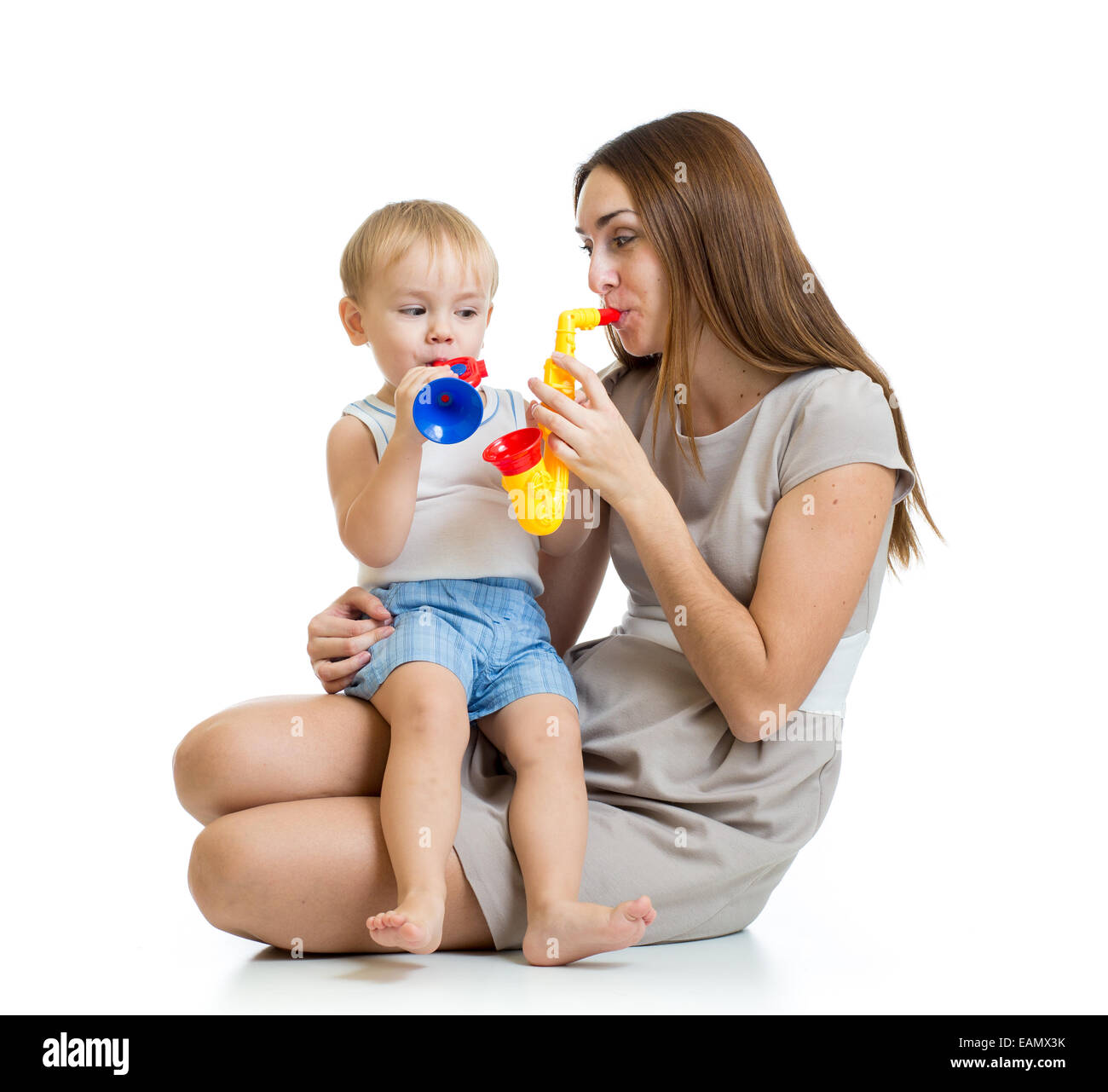 child and mother play musical toys isolated Stock Photo