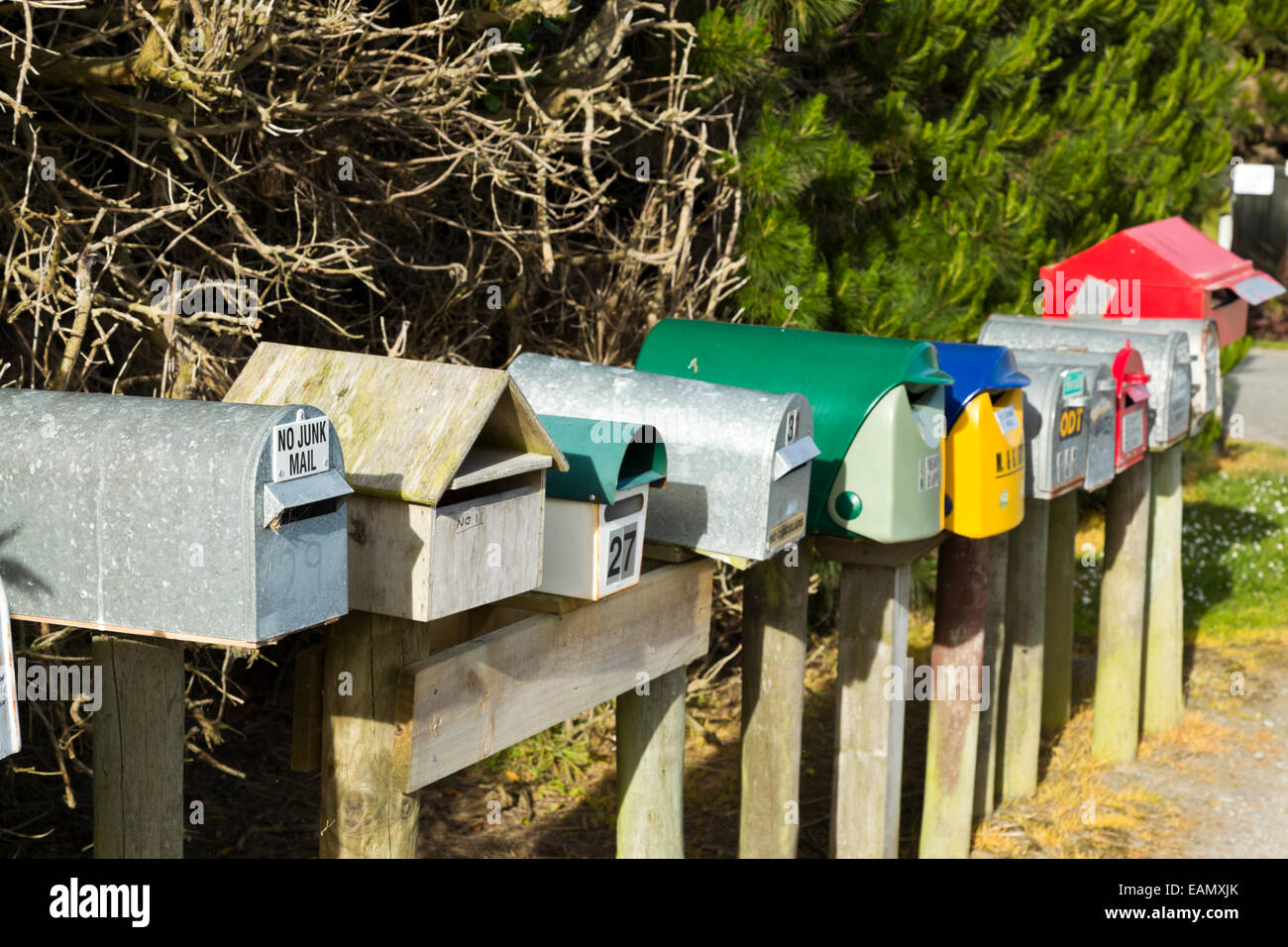 A row of post boxes on a rural road in New Zealand South Island Stock