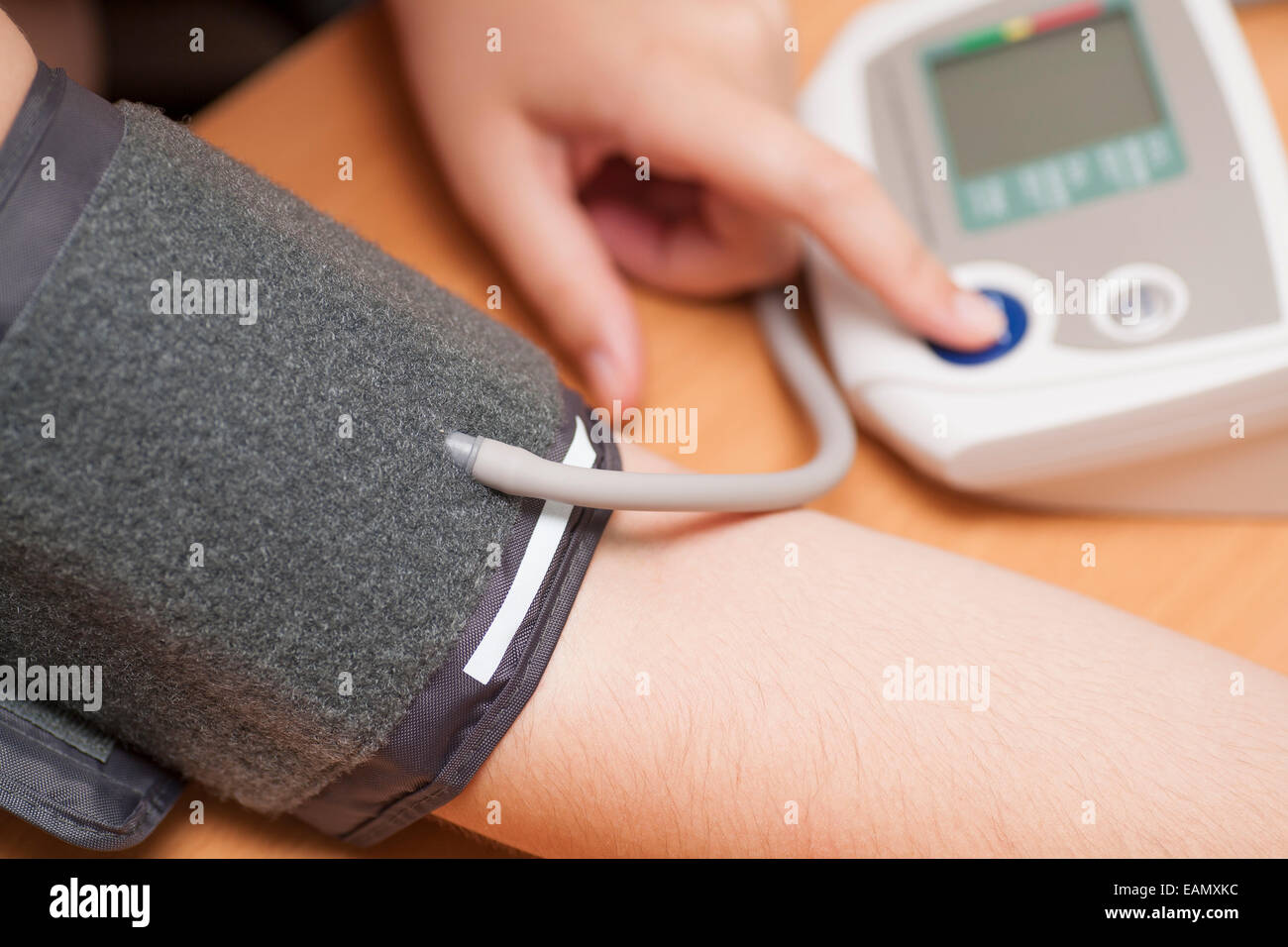 Woman checking blood pressure and heart rate with a digital blood