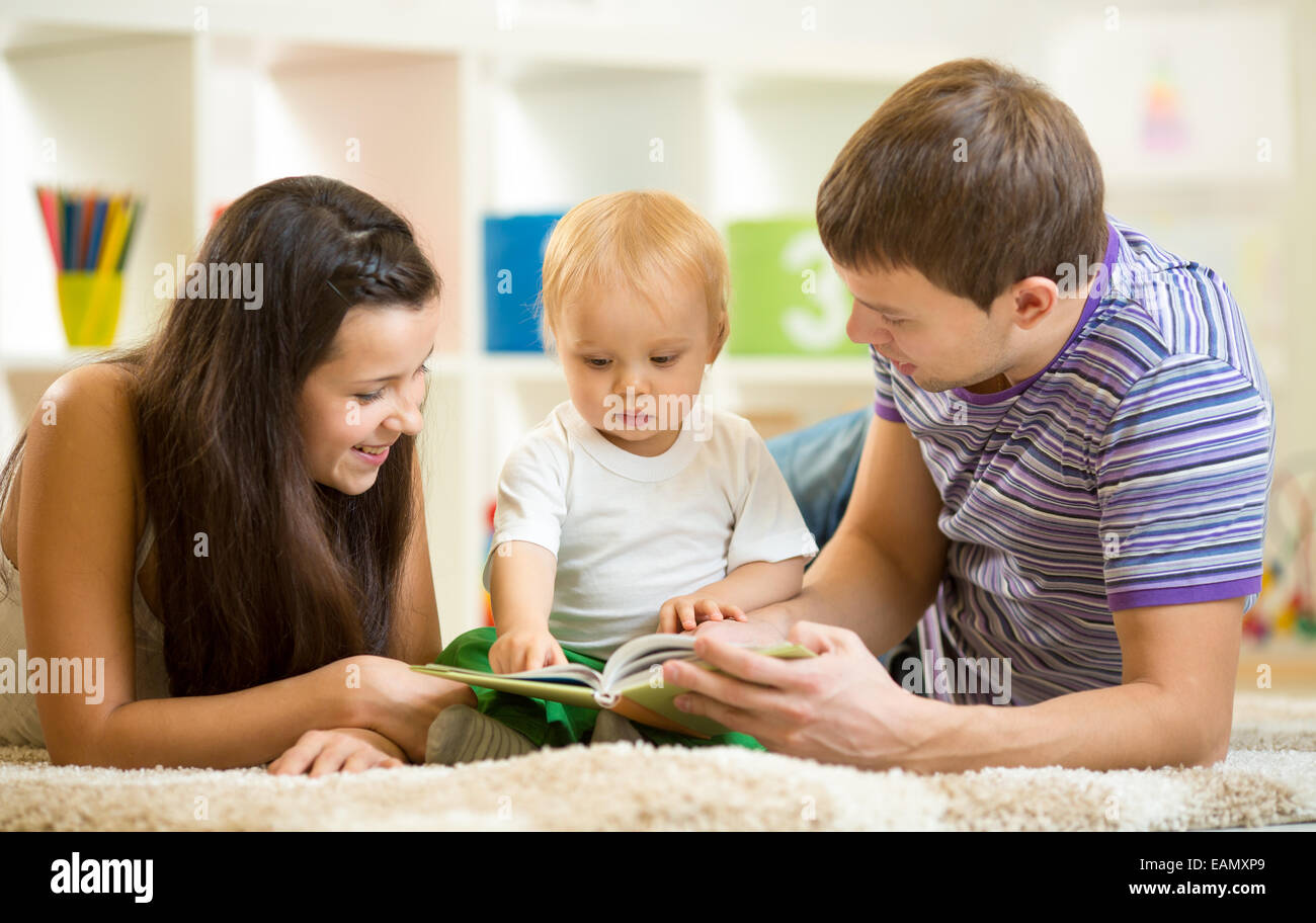 Young happy family with kid boy read children book Stock Photo Alamy