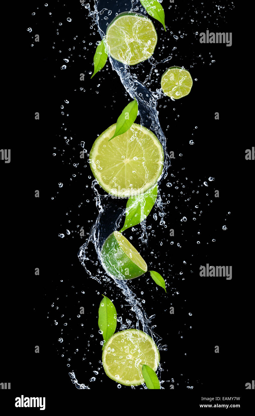 Limes in water splash, isolated on black background Stock Photo