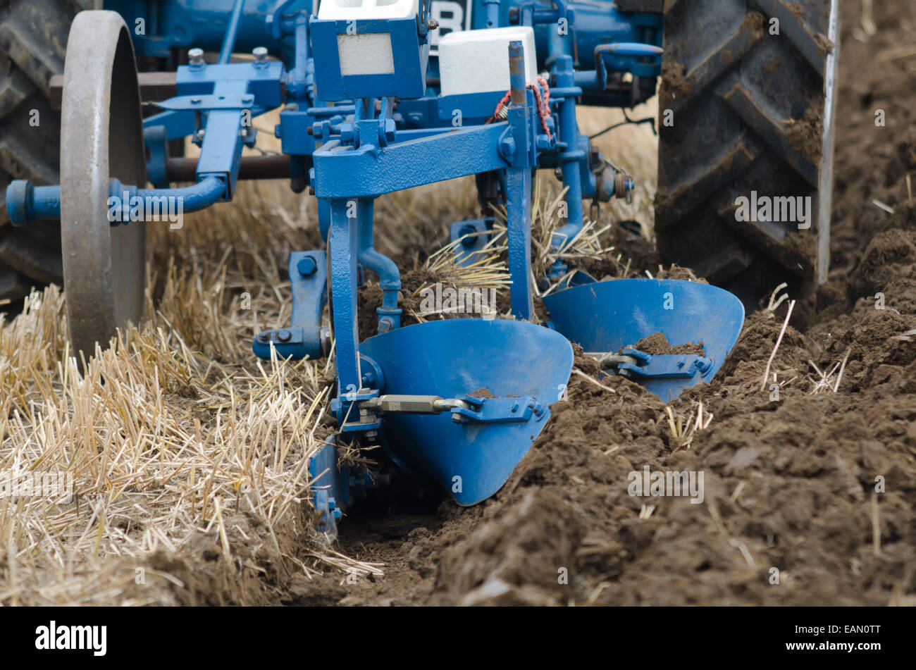A tractor ploughing  close up Stock Photo
