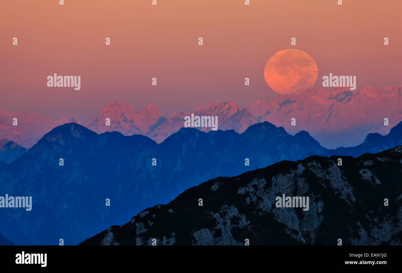 Big moon over the mountain tops in Italy. Stock Photo