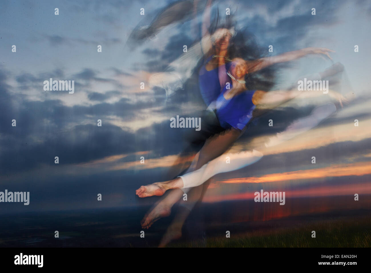 Ballerina dancing on a hilltop at sunset (contains motion blur) Stock Photo