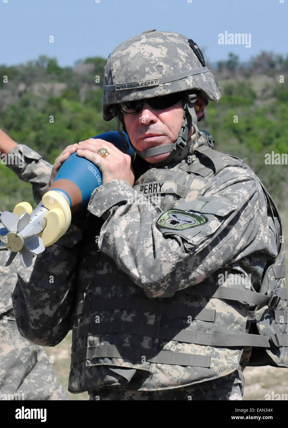 Texas Governor Rick Perry holds a mortar rocket during a visit to the Division Mortar School at Curry Mortar Range August 5, 2013 in Fort Hood, Texas. Stock Photo