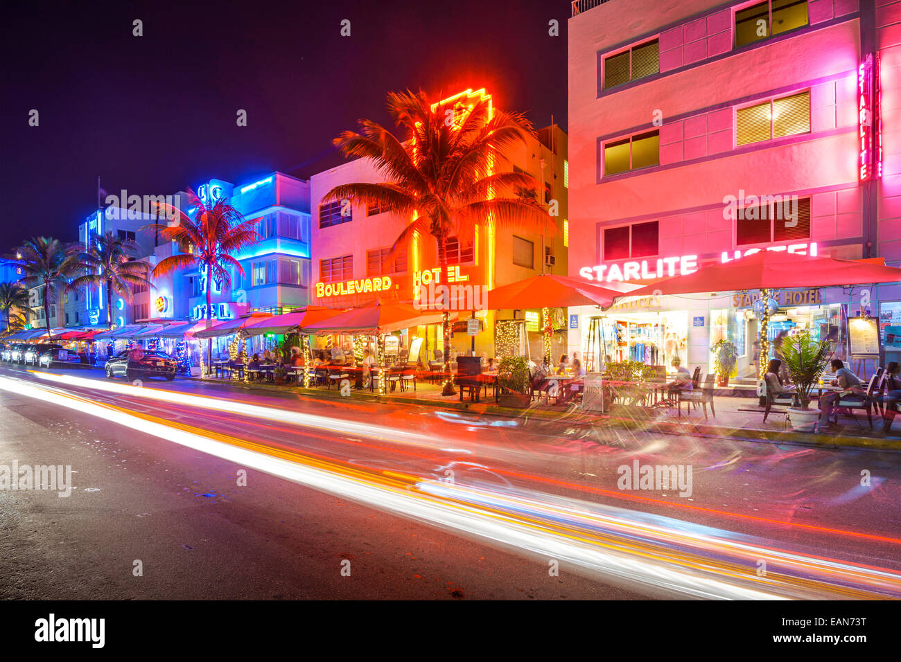 MIAMI, FLORIDA - JANUARY 6, 2014: Cars speed down Ocean Drive. The road is the main thoroughfare through South Beach. Stock Photo