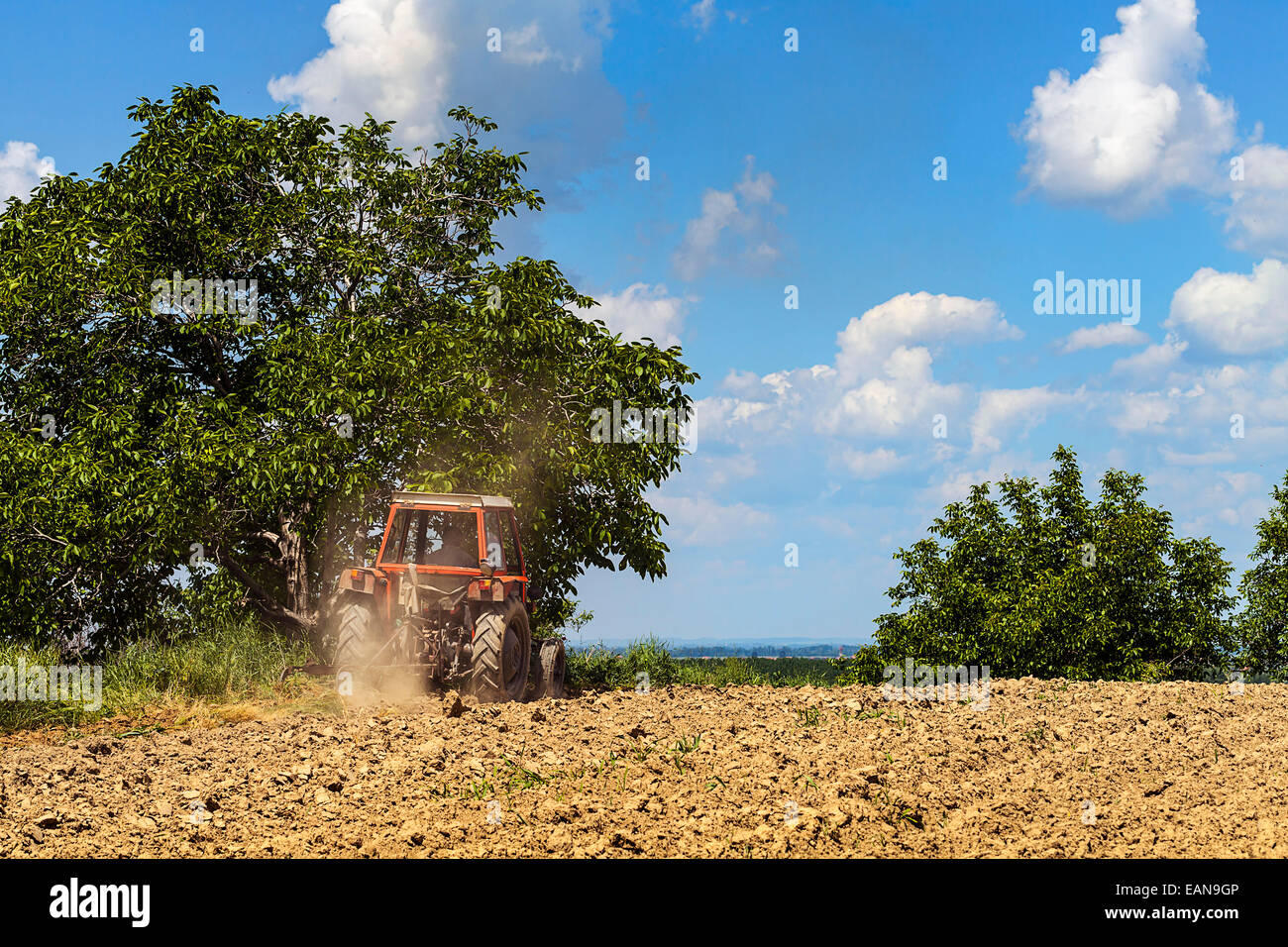 Tractor plowing the land Stock Photo - Alamy