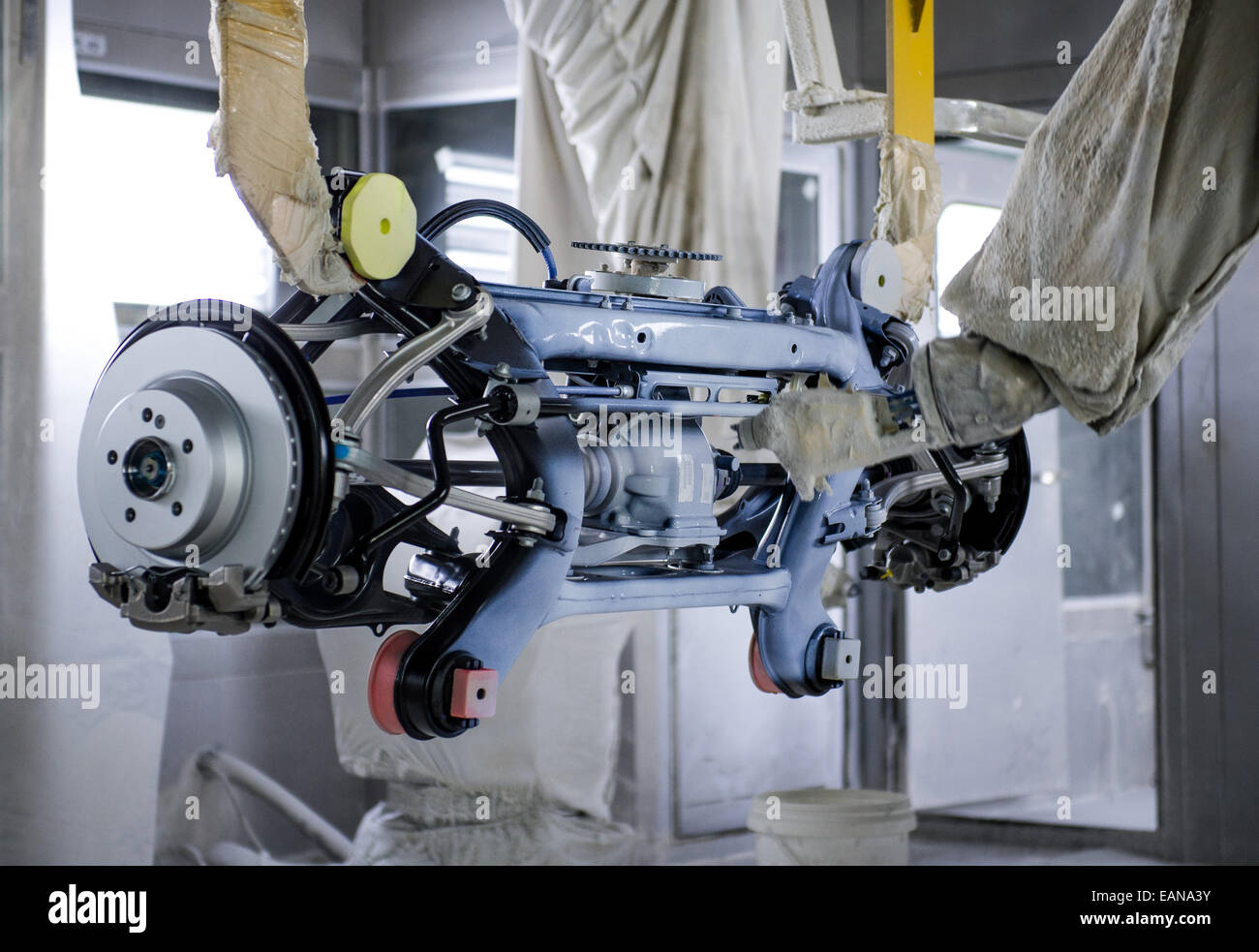 A front wheel axle for Mercedes being painted by a robot in the ZF