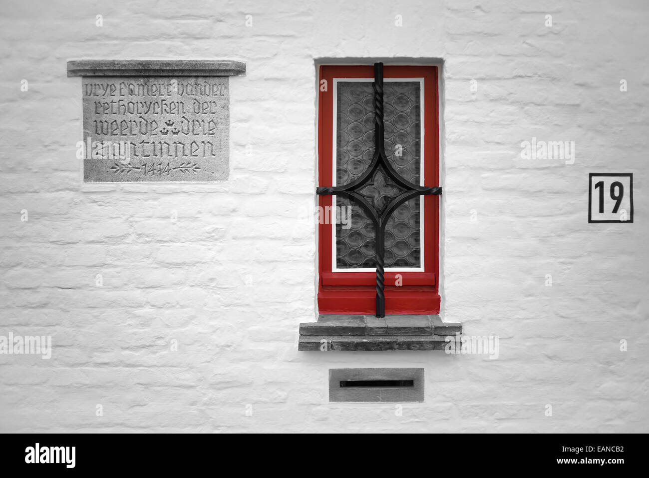 Old wall plaque and window in Brugges, Belgium Stock Photo