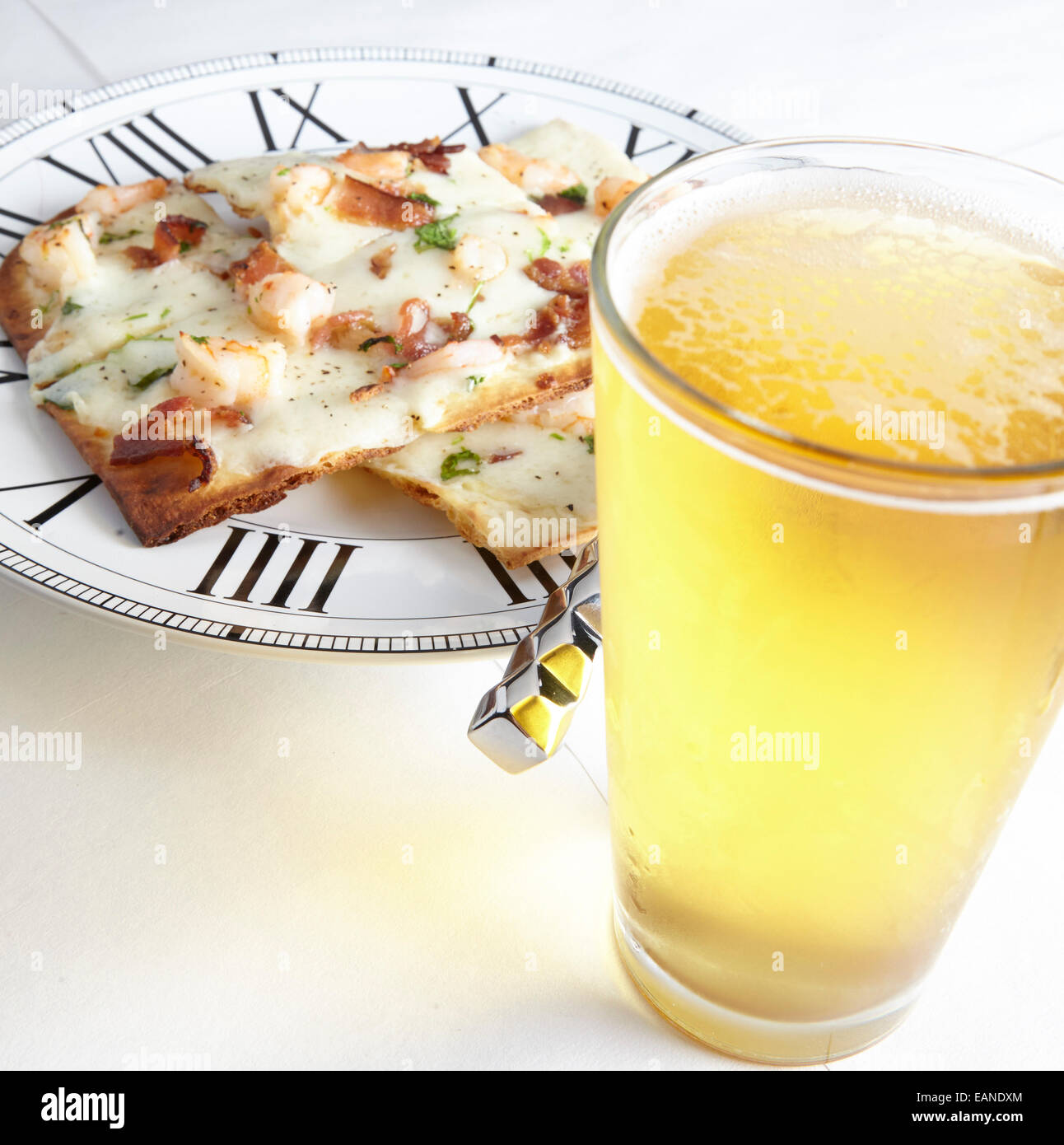 Shrimp flatbread with cilantro white cheddar Parmesan bacon with glass of cold beer Stock Photo