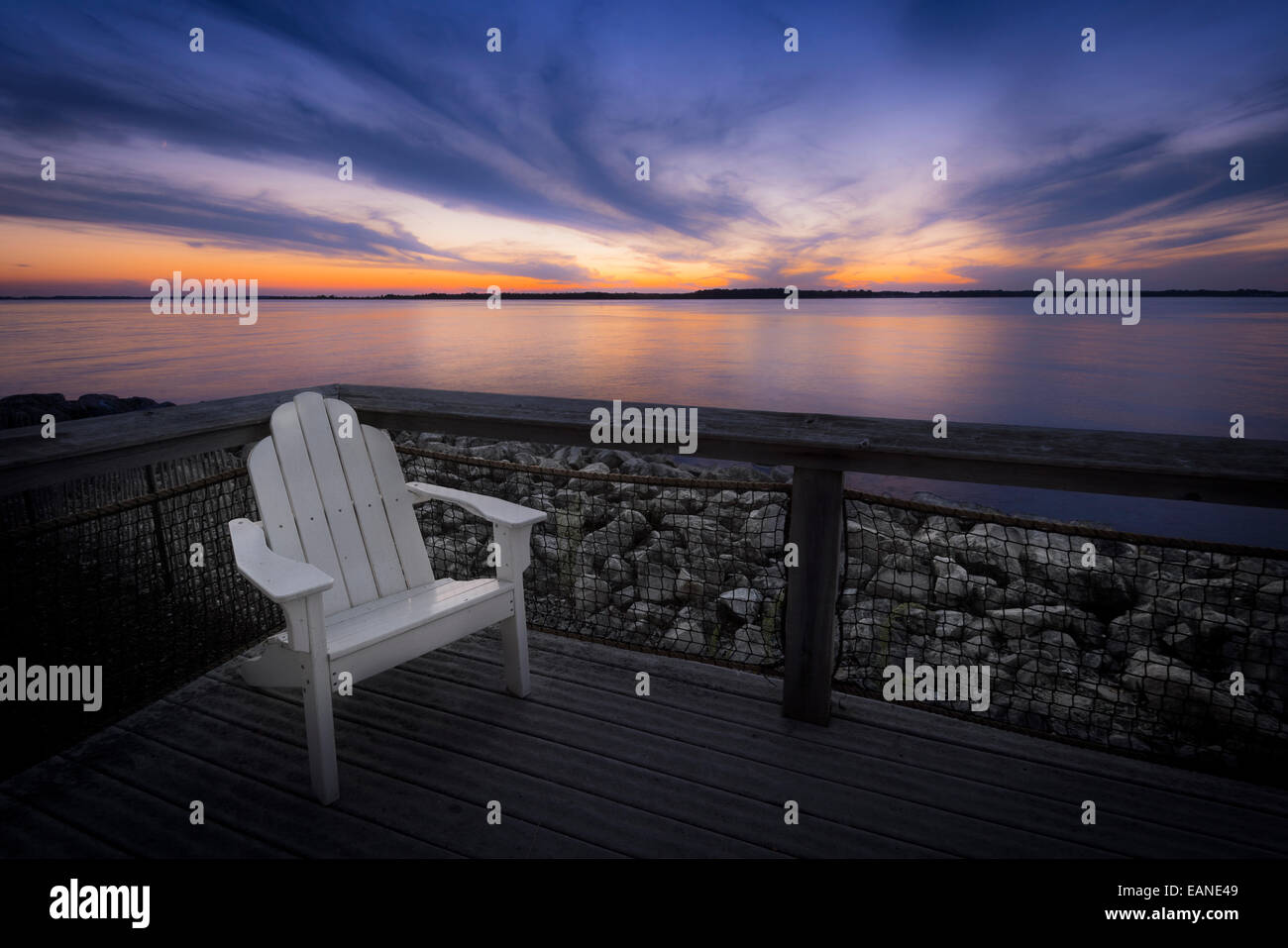 White Chair On Deck Lake At Sunset, Ohio, USA Stock Photo