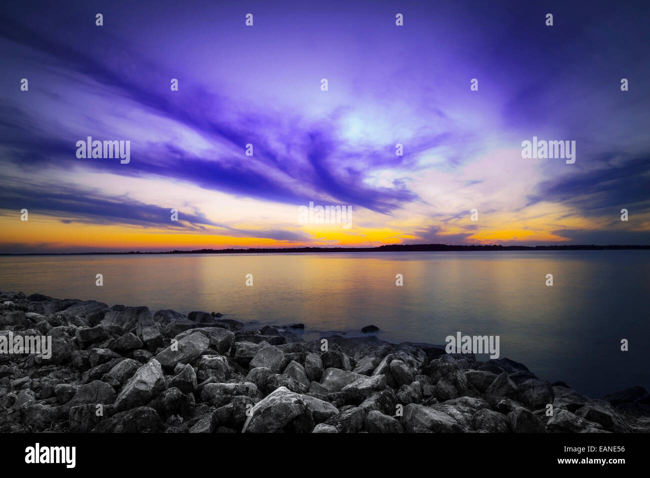 Rocky Lake Shoreline With Sunset Stock Photo
