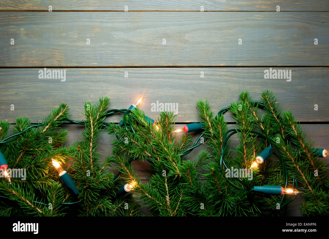 Christmas border tree lights with space on wood Stock Photo