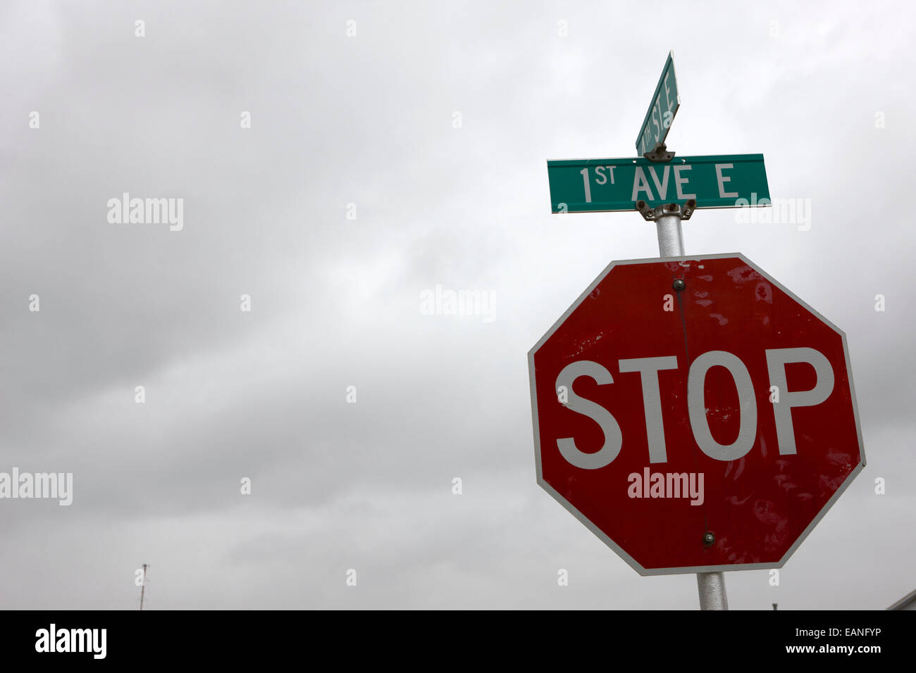 stop sign at junction of first street and first avenue on a cold grey day assiniboia Saskatchewan Canada Stock Photo