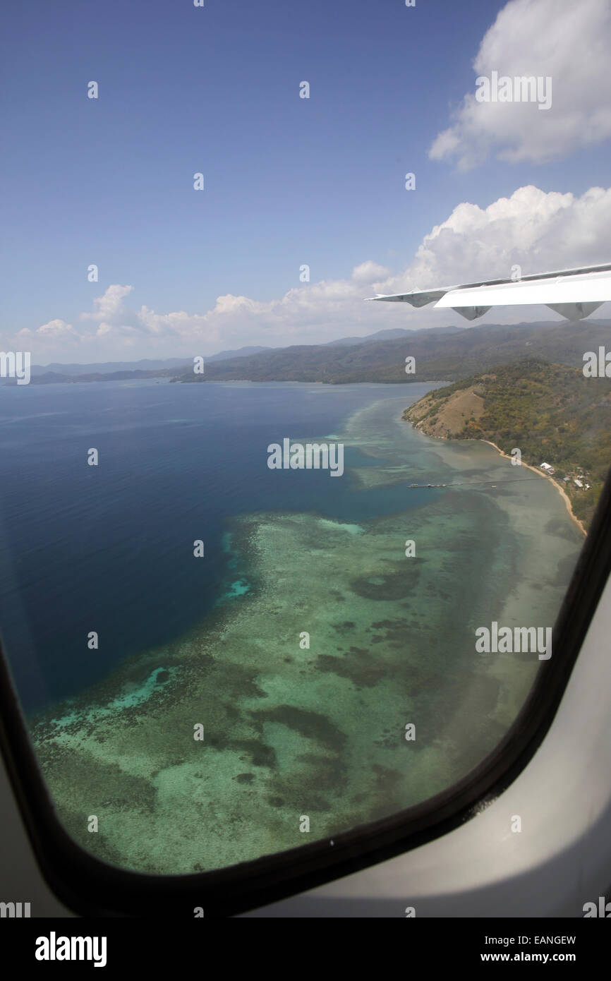 View of tropical coral reef on Flores Island from airplane window Stock Photo
