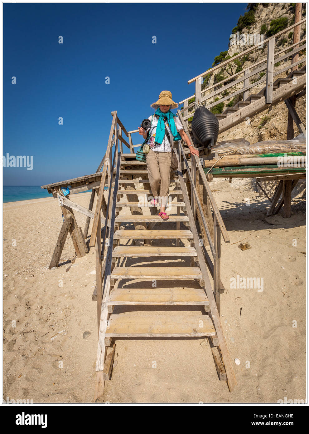 My partner descending the final few steps of the 325 steps leading down to the Egremni beach on the island of Lefkada in Greece. Stock Photo