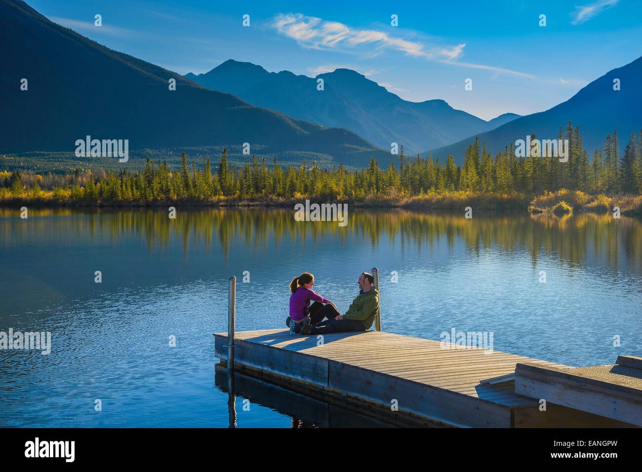 Banff Dock Couple on dock at Vermilion Lakes, Banff National Park, Alberta, Canada ...
