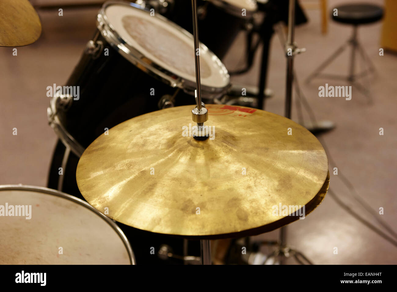 well used cymbal on a drum kit in a music training room Stock Photo