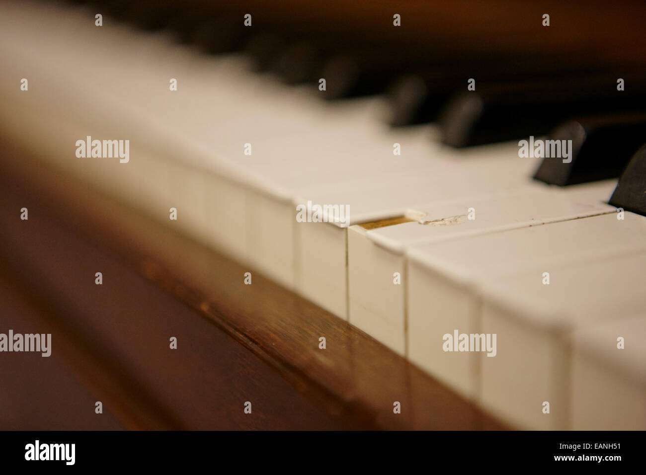 chipped key on a baby grand piano in a music training room Stock Photo