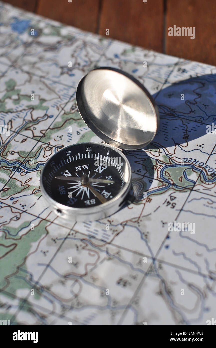 Map and compass. The magnetic compass is located on the topographic map ...