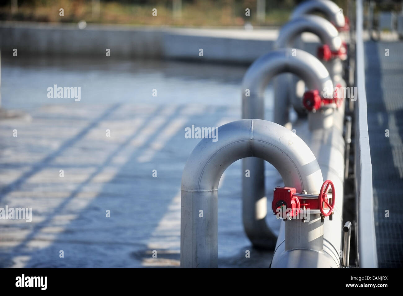 Industrial pipes from a waste water treatment plant Stock Photo
