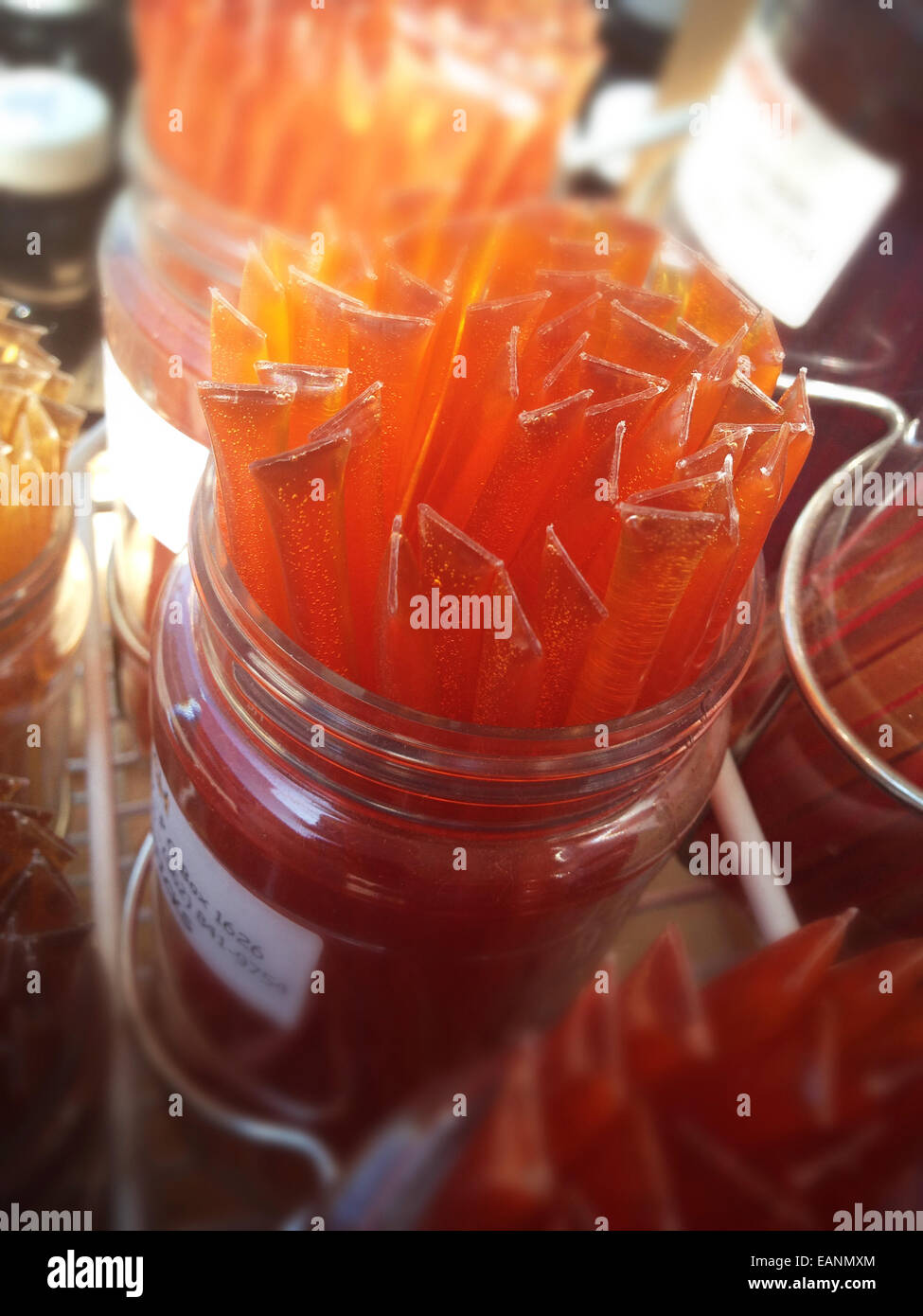Honey Sticks in a glass jar at Farmers Market studio city CA Stock Photo