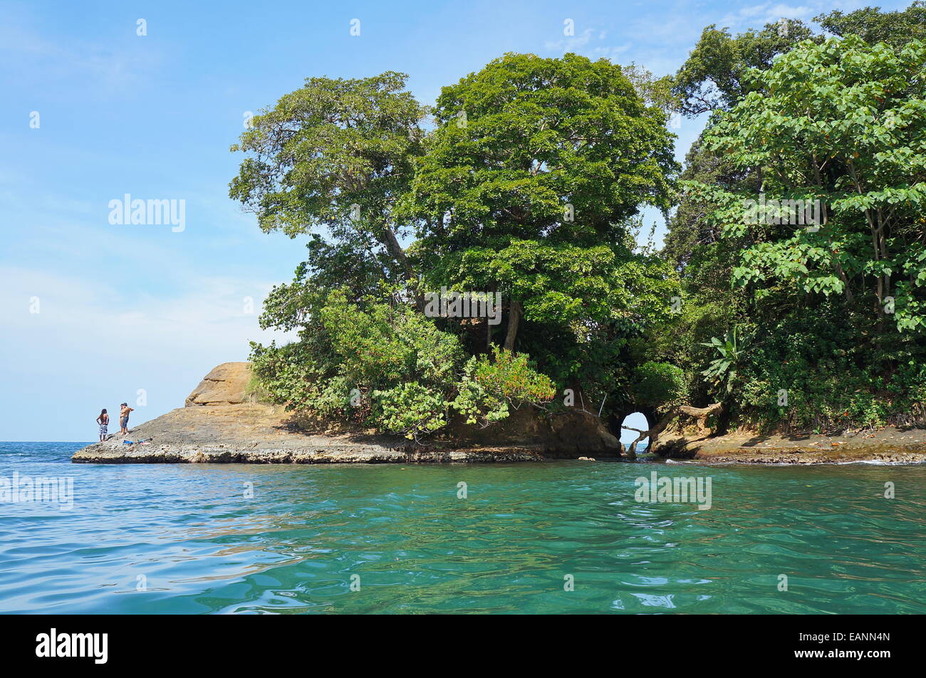 Caribbean shore of Costa Rica with a natural cave in the rock and lush tropical vegetation, Punta uva, Puerto Viejo Stock Photo