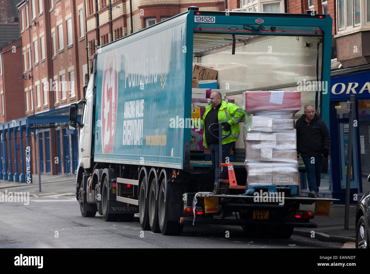 Two men delivering to 'Poundland' store King Street, Southport, UK ...