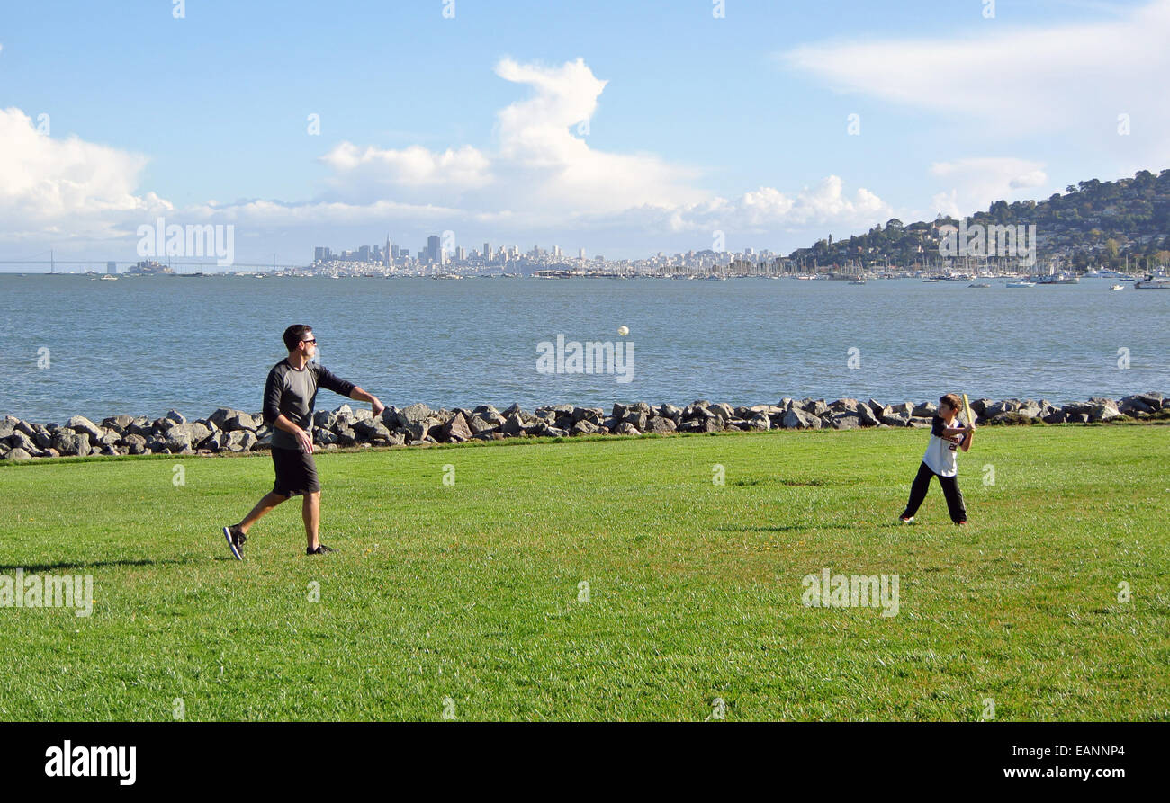 father and son playing ball in Mill Valley park on San Francisco Bay Stock Photo