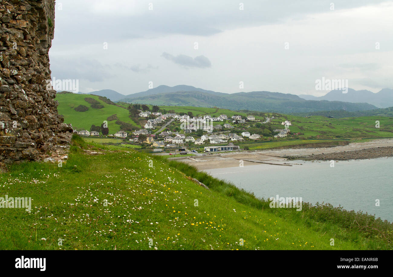 View, from hilltop castle, of Welsh town of Criccieth by beach of Cardigan Bay & green fields stretching to distant mountains Stock Photo