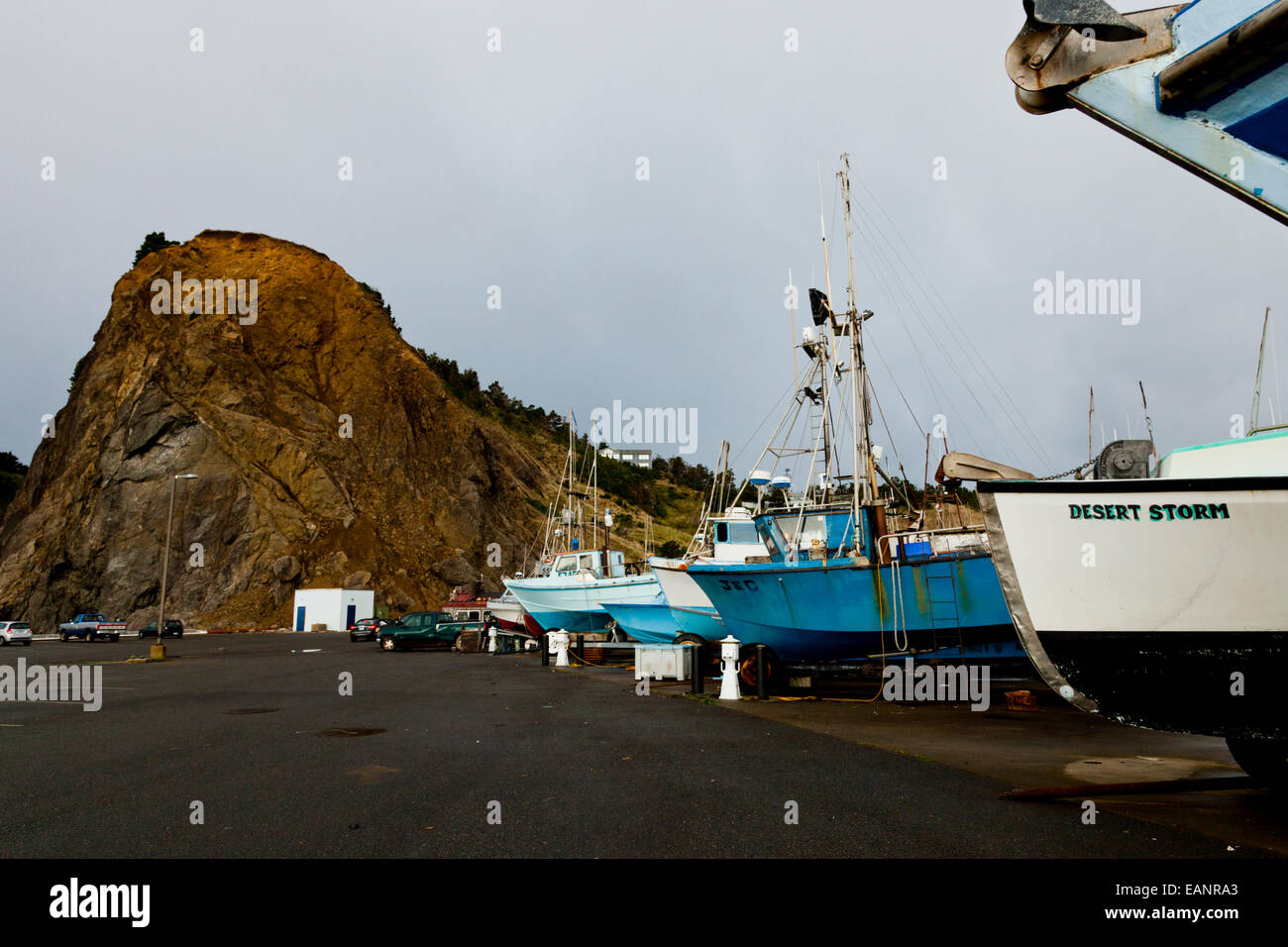 Sail boats in Port Orford dolly dock with Port Orford Rock in the
