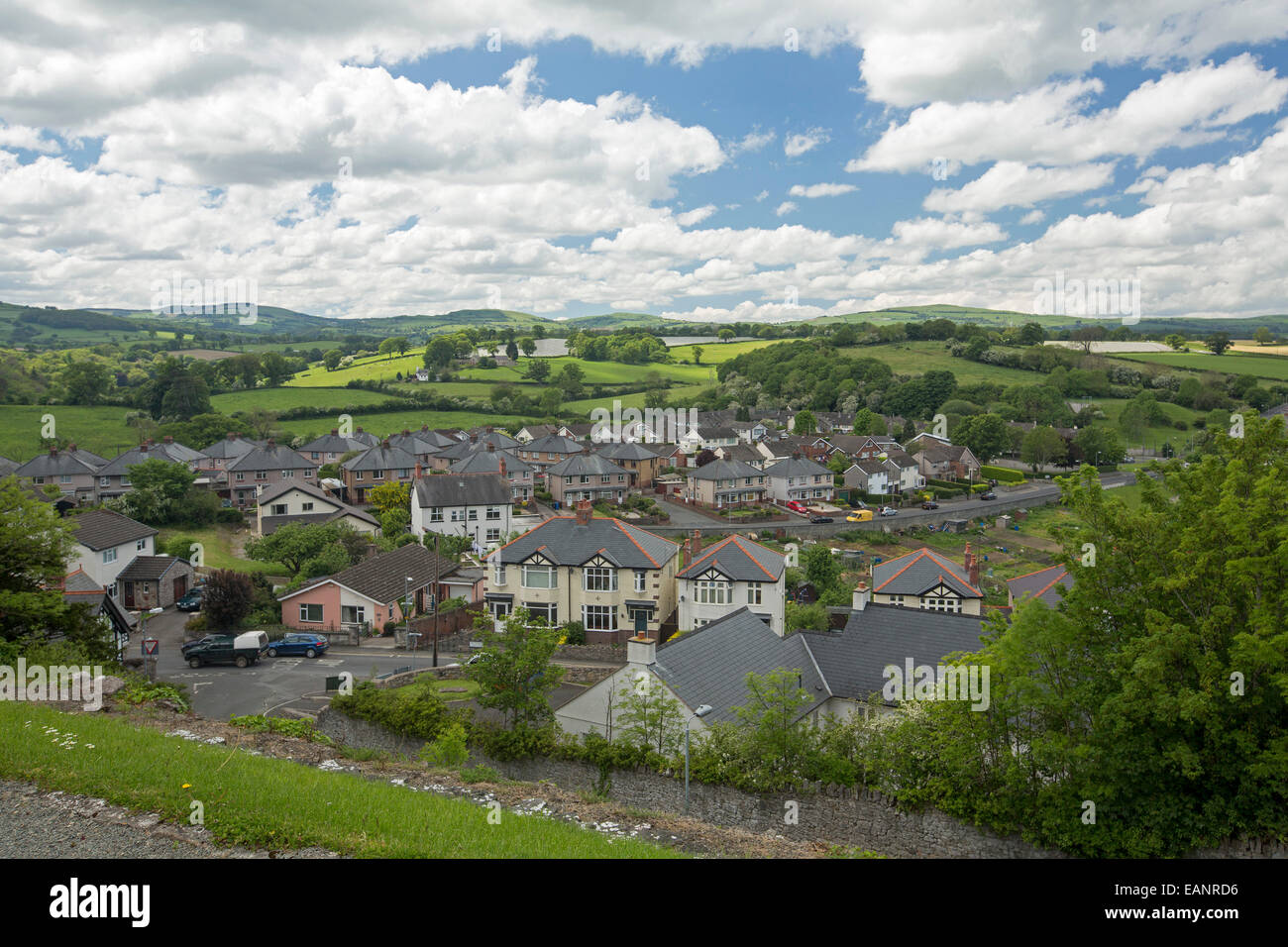 View, from hilltop castle, of historic Welsh town of Denbigh surrounded by emerald farmlands that stretch to low hills & horizon Stock Photo
