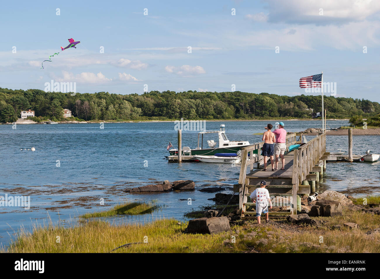 Kite flying off of dock near Chauncey Creek in Kittery Maine Stock