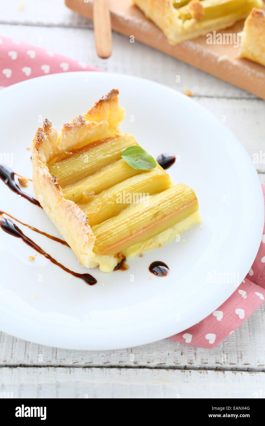 Piece of sweet pie with rhubarb on a plate, food closeup Stock Photo