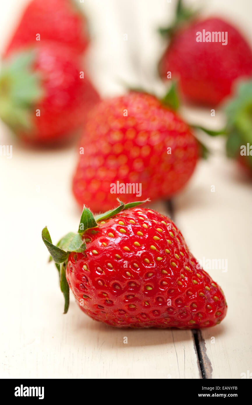 fresh organic strawberry over white rustic wood table Stock Photo - Alamy