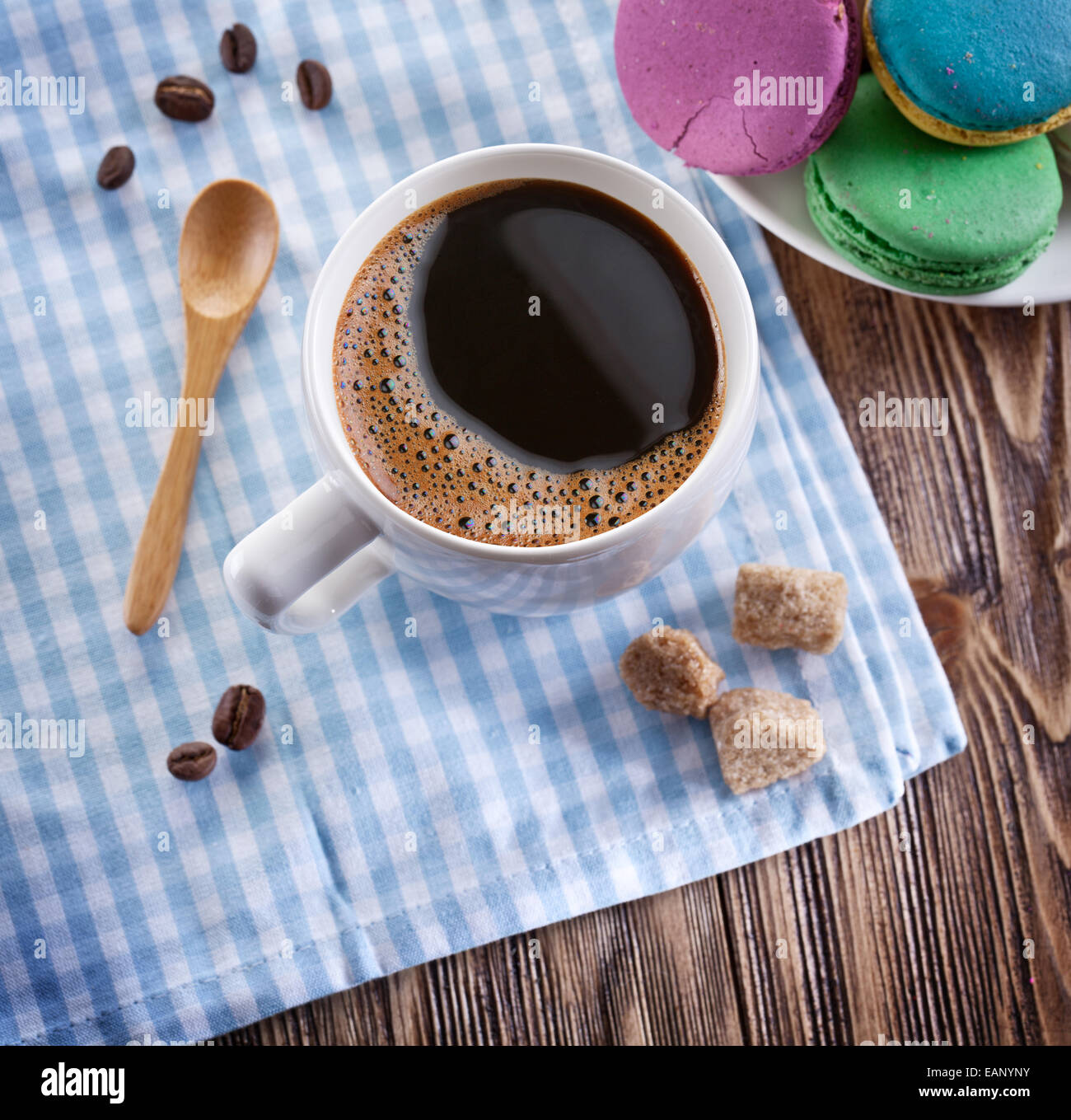 Cup of coffee and french macaron on an old wooden table. Stock Photo