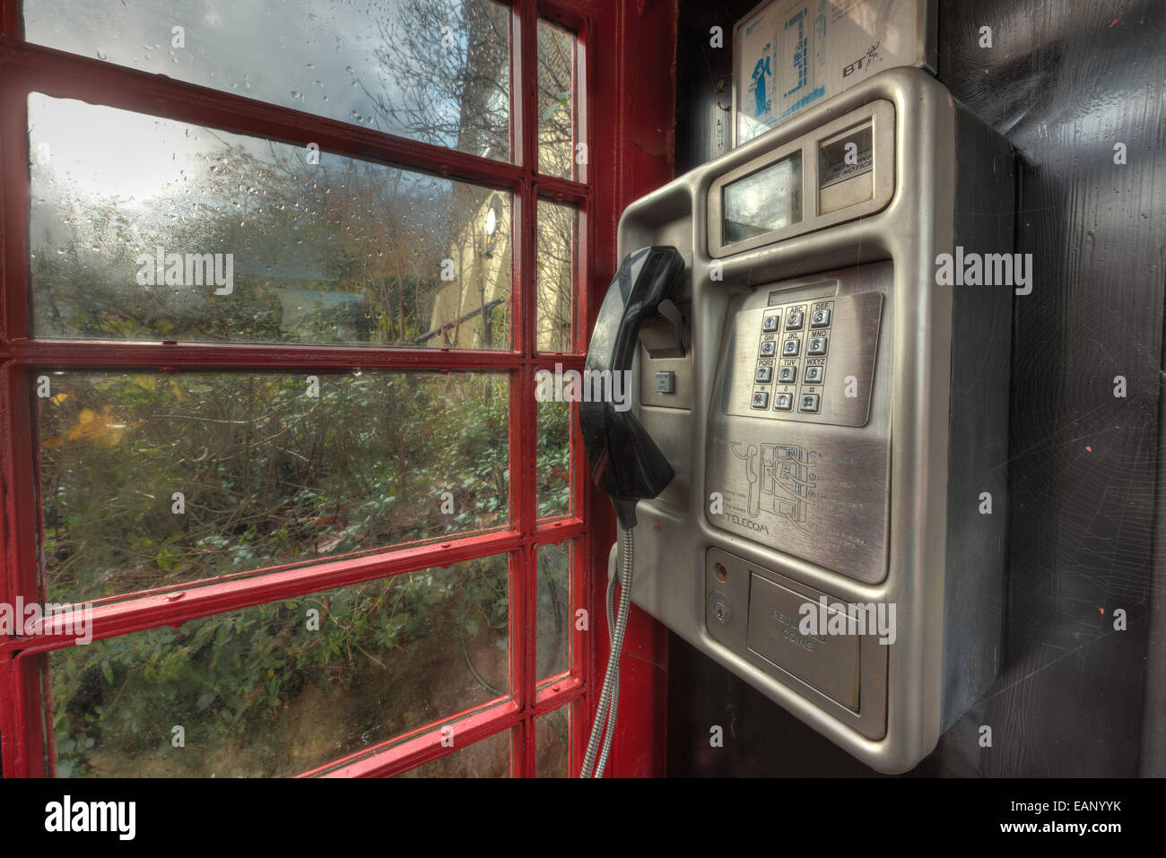 traditional old fashioned unused red telephone box illustrating changing communication cultures and redundant old technology Stock Photo