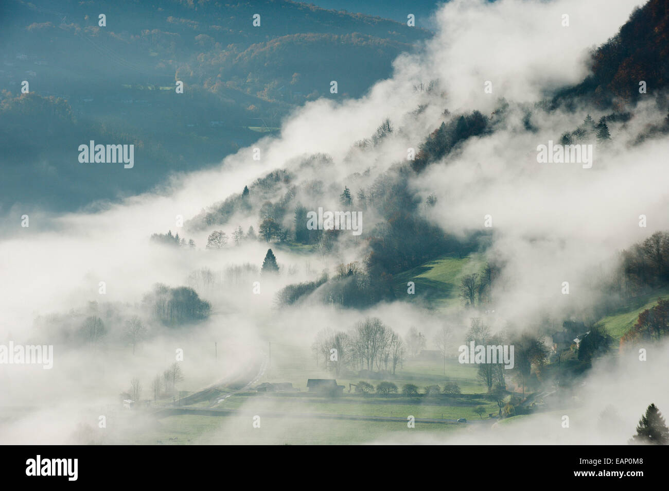 Val D'Arly, Savoie, France. 19th November, 2014. Mist rises as the morning warms up after a cold night. After several days of rainy weather at low altitude and Snow at high altitude the morning breaks with a clear blue sky. Credit:  Graham M. Lawrence/Alamy Live News. Stock Photo