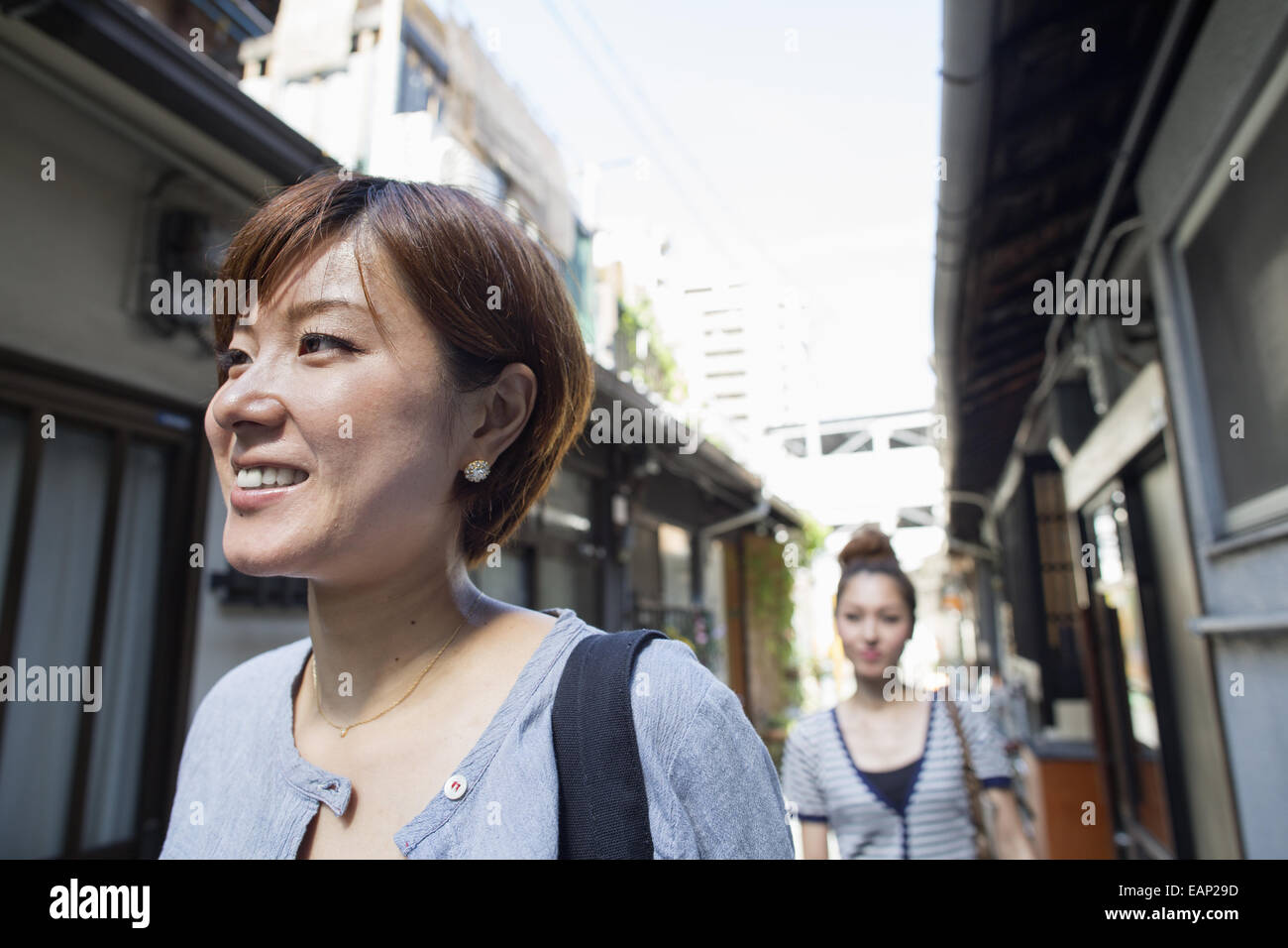 Two women standing outdoors, smiling Stock Photo - Alamy