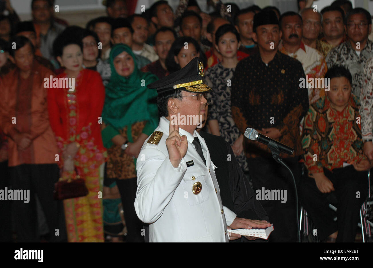 (141119) -- JAKARTA, Nov. 19, 2014 (Xinhua) -- New Jakarta governor Basuki Tjahaja Purnama, better known by his nickname 'Ahok', swears during the inauguration ceremony at President Palace in Jakarta, Indonesia, Nov. 19, 2014. Acting Jakarta governor Basuki Tjahaja Purnama was inaugurated as the city's 17th governor for the period of 2012 to 2017 by President Joko Widodo at the Presidential Palace on Wednesday. (Xinhua/Agung Kuncahya B.) (azp) Stock Photo