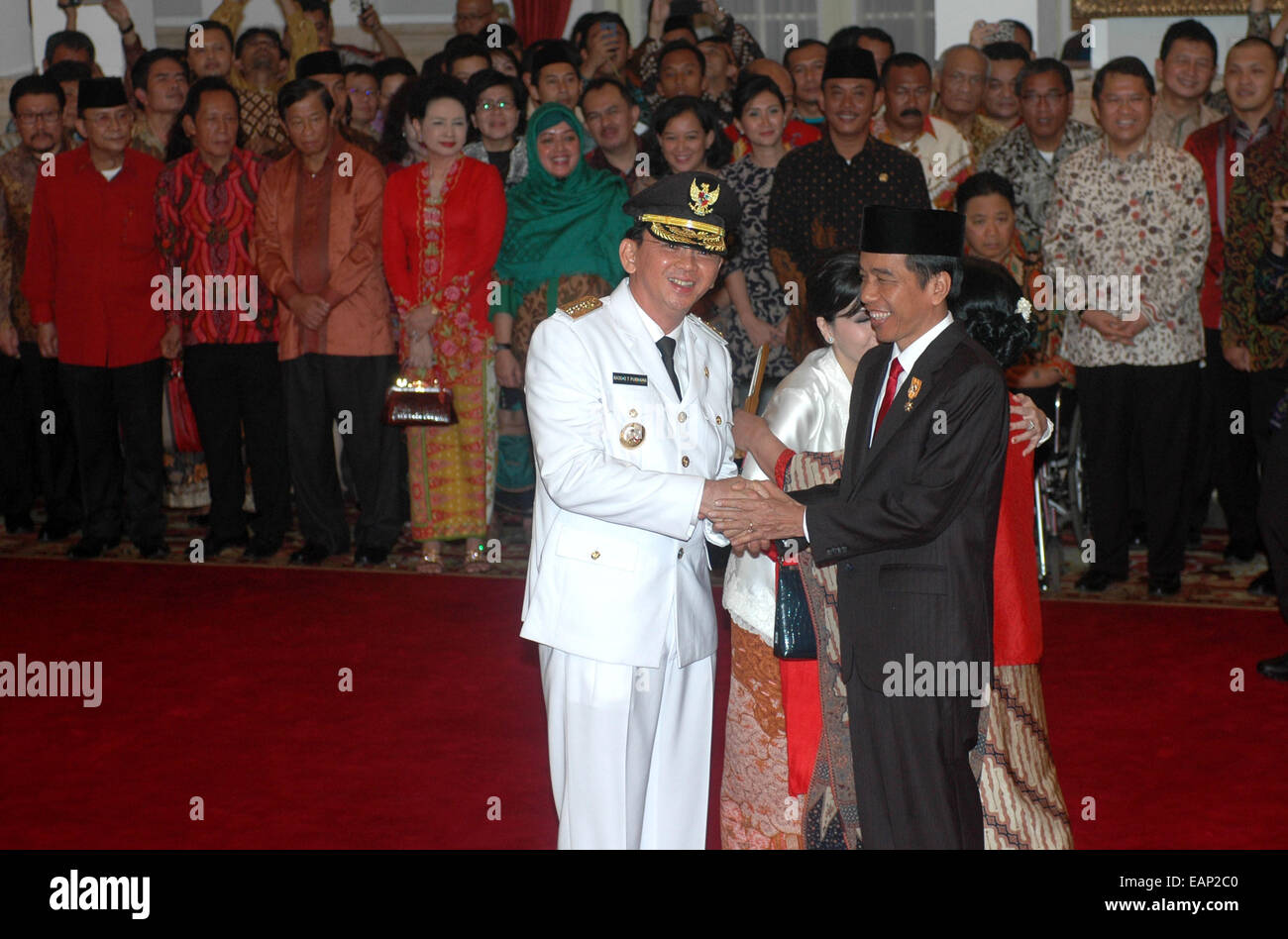 (141119) -- JAKARTA, Nov. 19, 2014 (Xinhua) -- Indonesian President Joko Widodo (R) shakes hands with new Jakarta governor Basuki Tjahaja Purnama at President Palace in Jakarta, Indonesia, Nov. 19, 2014. Acting Jakarta governor Basuki Tjahaja Purnama was inaugurated as the city's 17th governor for the period of 2012 to 2017 by President Joko Widodo at the Presidential Palace on Wednesday. (Xinhua/Agung Kuncahya B.) (azp) Stock Photo