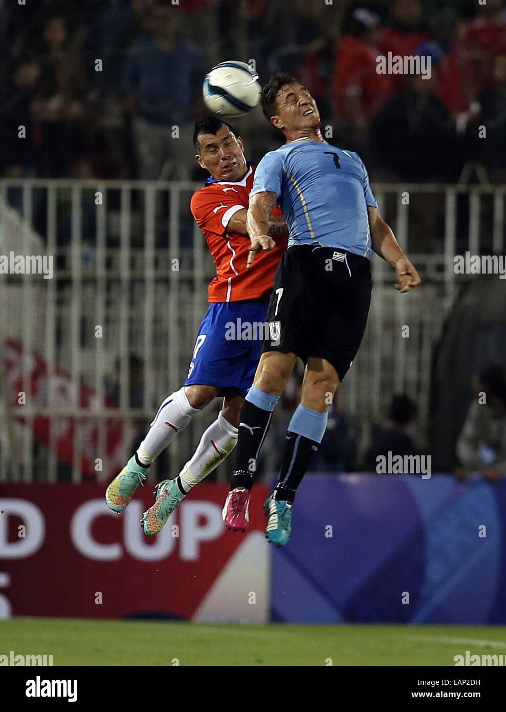 Santiago, Chile. 18th Nov, 2014. Image provided by National Association of Professional Soccer (ANFP, for its acronym in Spanish) of Chile shows Chile's Gary Medel (L) vying with Cristian Rodriguez (R) of Uruguay, during a friendly match at Monumental Stadium, in Santiago, Chile, on Nov. 18, 2014. © ANFP/Xinhua/Alamy Live News Stock Photo
