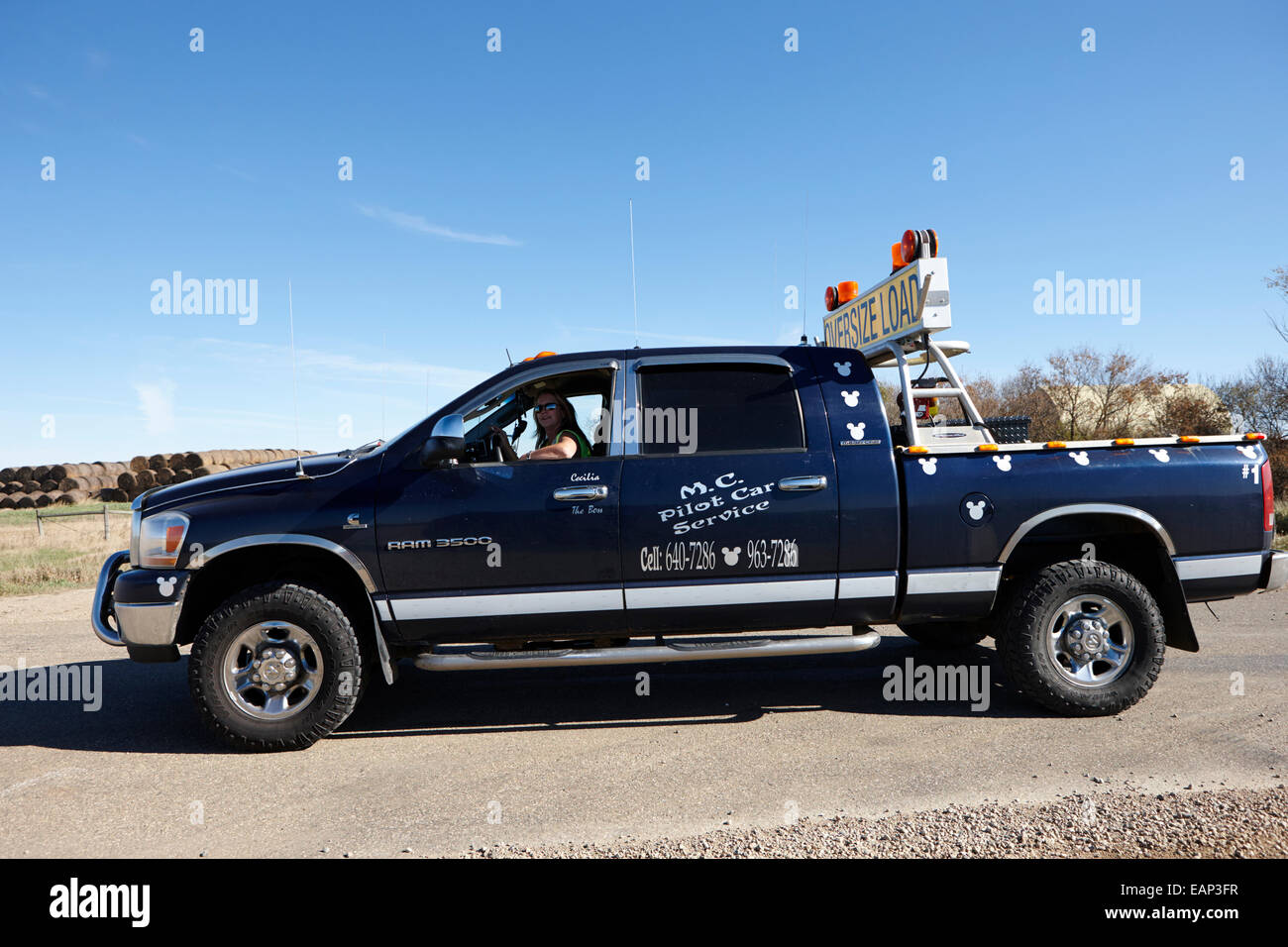 pilot car pickup truck accompanying an oversized load Saskatchewan Canada Stock Photo