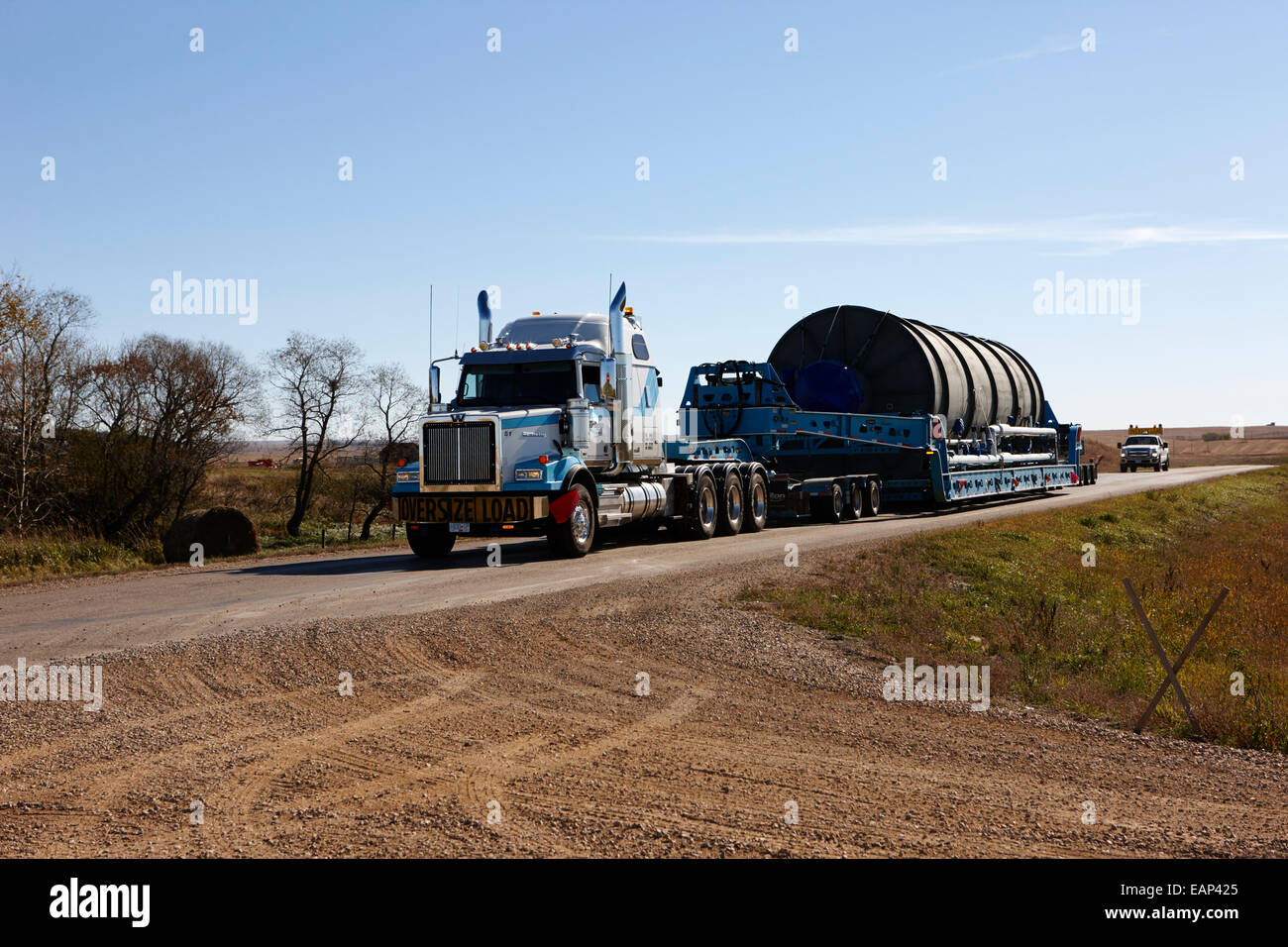 oversize load transporting a grain silo on local rural road Saskatchewan Canada Stock Photo