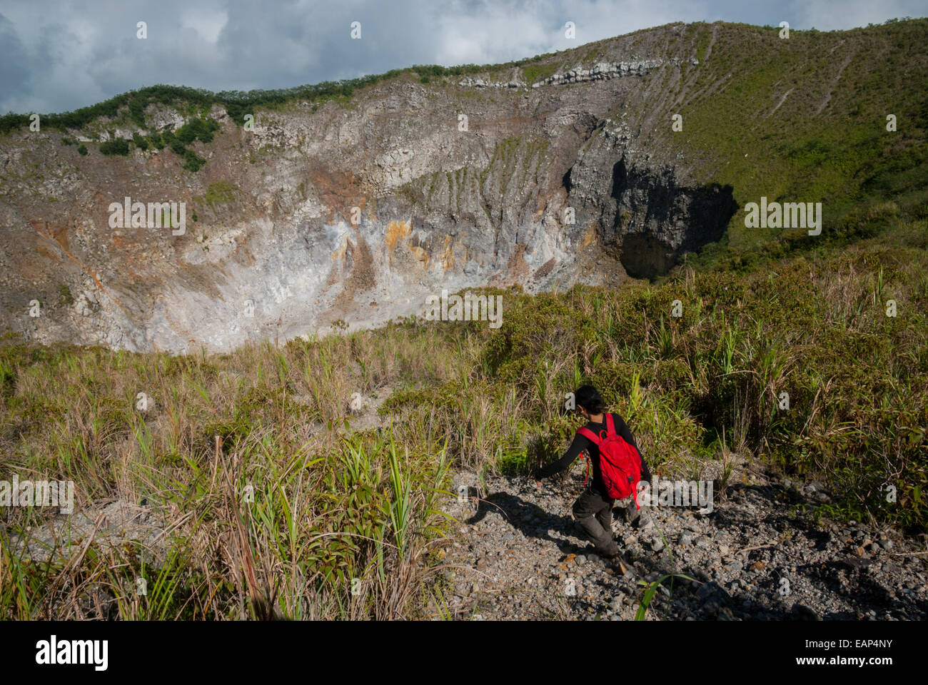 A journalist is stepping on the crater rim of Mount Mahawu volcano in Tomohon, North Sulawesi, Indonesia. Stock Photo