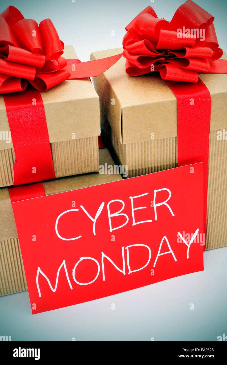a pile of gifts and the text cyber monday written in white in a red signboard Stock Photo