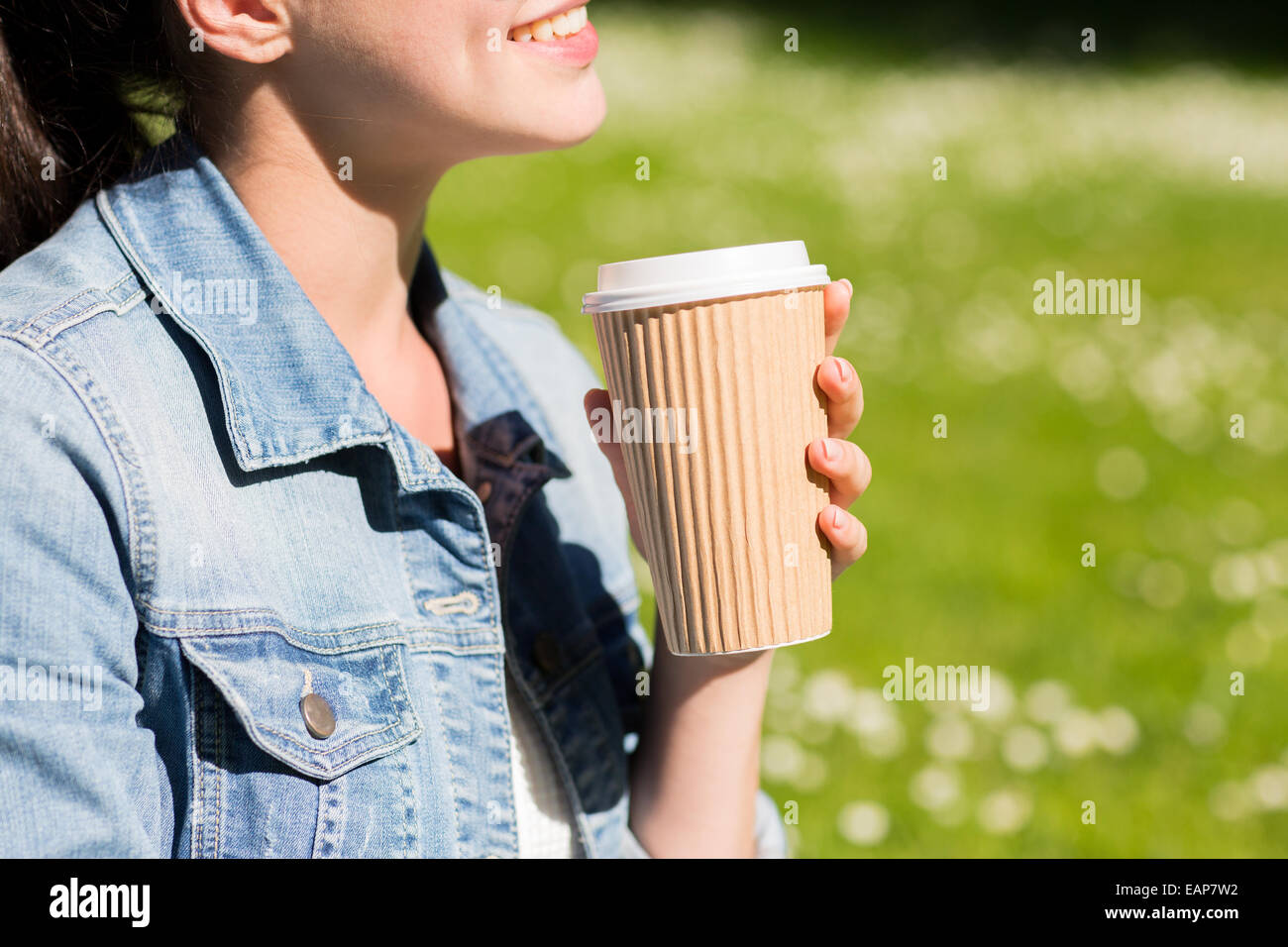 close up of smiling girl with coffee cup outdoors Stock Photo