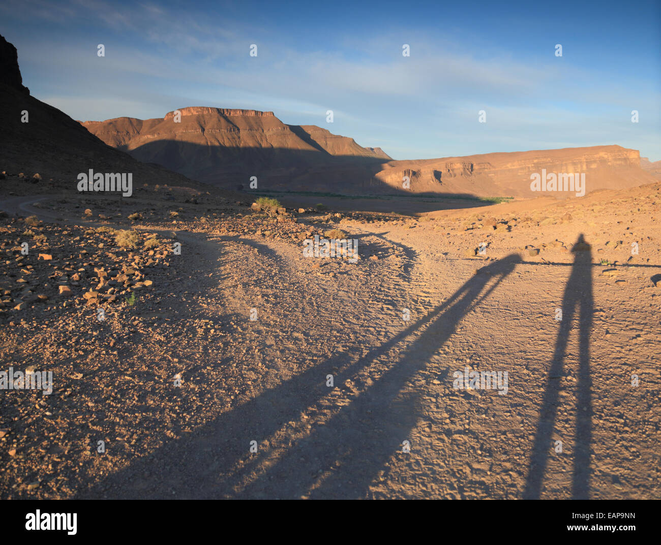 Shadows of people in rising sun just after dawn in the Jebel Sahro ...