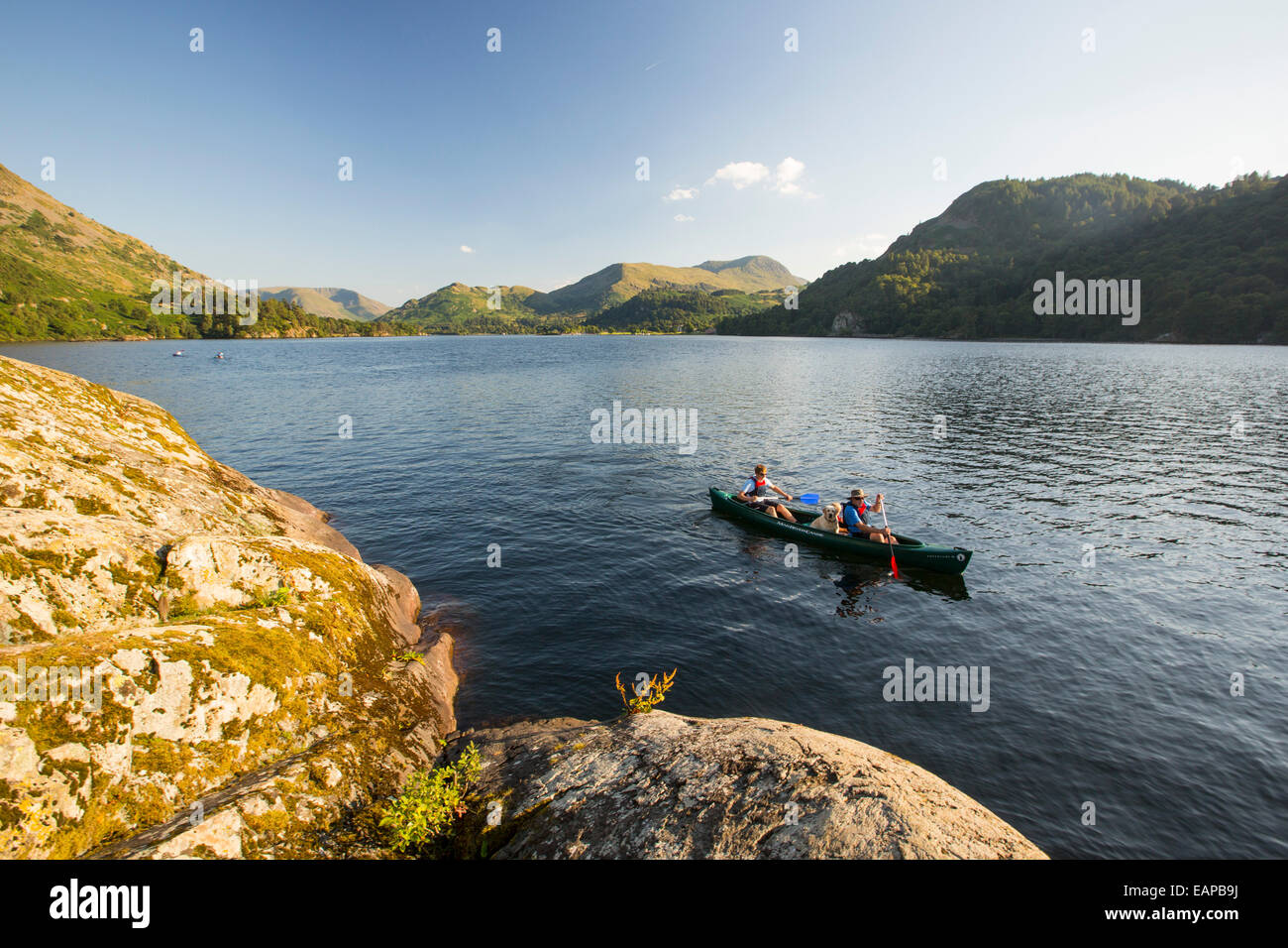 A family paddling in a Canadian Canoe on Ullswater in the Lake District