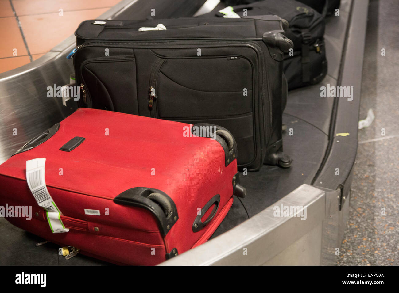 Luggage on conveyor belt at London Gatwick Airport. Baggage retrieval Stock Photo